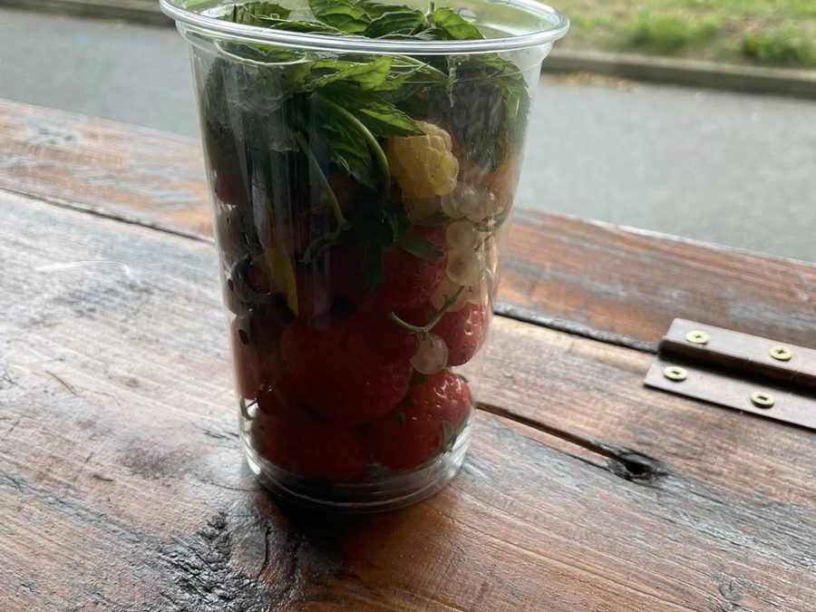 Fresh fruit and mint iced drink served on a wooden table