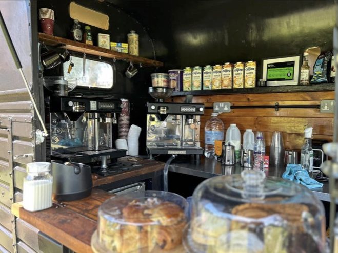 Inside the trailer: espresso machines and fresh bakes under glass domes
