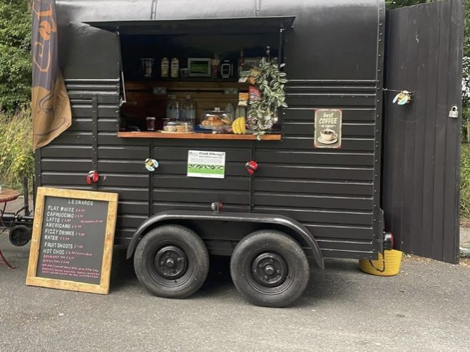 Leonard's Coffee trailer with the drinks menu chalkboard out front